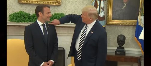 Trump flicks dandruff off Macron's jacket. Photo: ABC News/YouTube screenshot