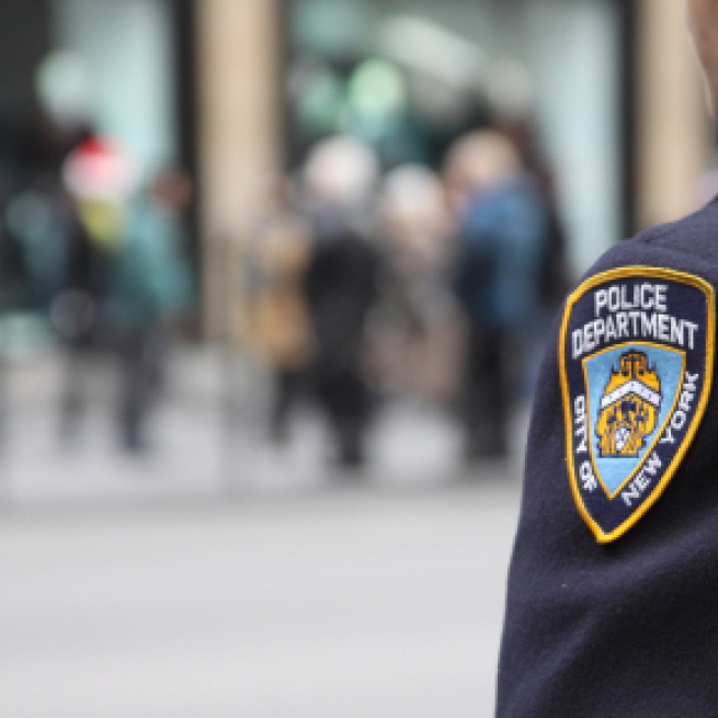 New York City Police officer stands guard (Image via Dave Hosford - Flickr)