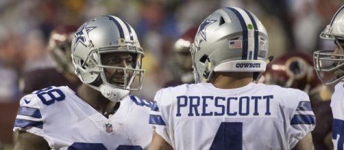 Dez Bryant and Dak Prescott talking during a game against the Redkins. - [Image via Keith Allison / Wikimedia Commons]