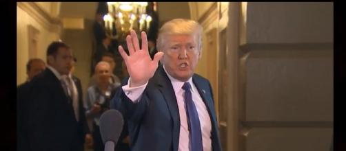 Trump puts up his hand. - [Photo: US Breaking News / YouTube Screenshot]
