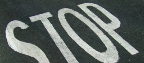 Scritta Stop sull'asfalto di una strada