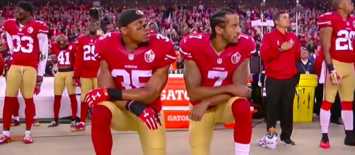 Former teammates Colin Kaepernick and Eric Reid kneel before a game versus the L.A. Rams. [ABC News/YouTube screenshot]