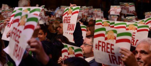 Iranians participating in 2017 Free Iran rally holding #Free Iran placards. Photo credit by The Media Express