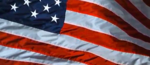 The American flag is often viewed as a symbol of freedom and opportunity. [Image source: FunnDevelopment/YouTube]