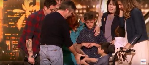 Adoptive dad, Michael Ketterer, celebrates his 'America's Got Talent' golden buzzer moment with Simon Cowell. -[AGT / YouTube screencap]