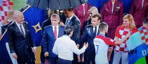 Putin riparato da un ombrello sotto il diluvio di Mosca
