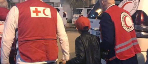 Albanian boy freed from IS camp on way home to Italy. [Image credit: Blasting News Database]