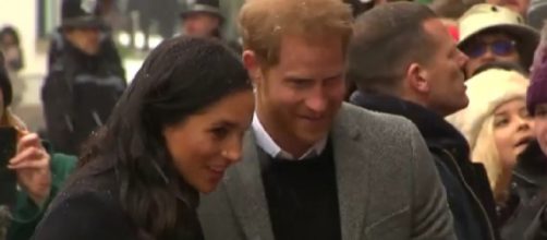 Prince Harry and Meghan Markle brave the snow to greet fans during royal visit to Bristol. [Image source/Global News YouTube video]