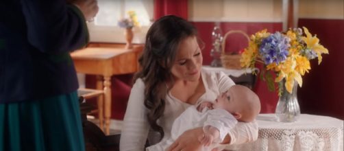 Elizabeth (Erin Krakow) has a hard time leaving baby Jack for her first day back to the classroom. [Image source:HallmarkChannel-YouTube]