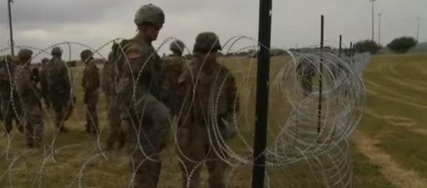 Military put up razor wire along Mexico border - Image credit - RT | YouTube Military put up razor wire along Mexico border - Image credit - RT | YouTube