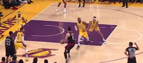 A play during Monday's Lakers game involved Kyle Kuzma shoving LeBron into defensive position. [Image via NBA/YouTube]