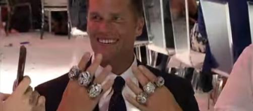 Tom Brady proudly displays his six Super Bowl rings (Image Credit: New England Patriots/YouTube)