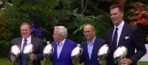 Tom Brady holds two of the Patriots' six Super Bowl trophies (Image Credit:New England Patriots/YouTube)