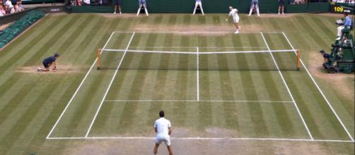 Federer going after Djokovic serve late in the fifth set. [Image Source: Wimbledon / YouTube]
