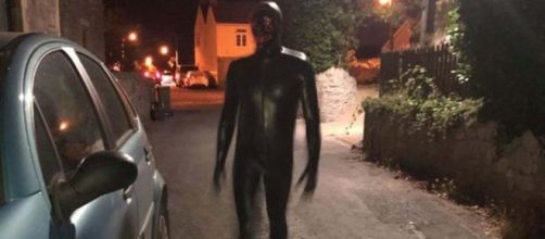 A man wearing a black rubber gimp suit is terrorising villagers in Claverham, Somerset [Image fabiano henrique araujo/YouTube]