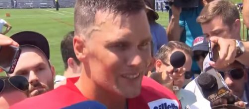 Tom Brady is swarmed by the media after practice, [Image Source: New England Patriots/YouTube]