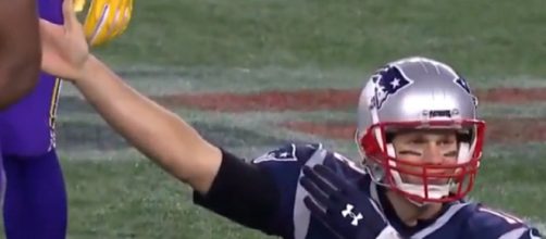 Tom Brady signals a first down after breaking the 1,000-rushing yards mark (Image Credit: Boston Sport/YouTube)