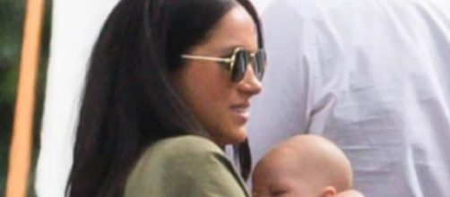 Meghan Markle cradles three month old Archie as she and Prince Harry land in south of France. [Image source/Breaking News YouTube video]