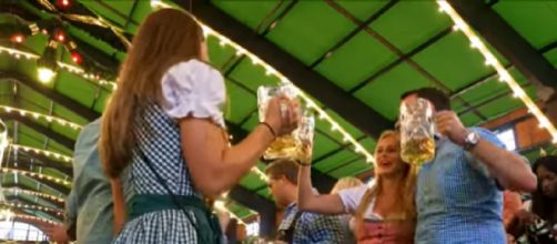 Revelers at Munich's Oktoberfest. [Image source- Rick Steve’s Europe | YouTube video]
