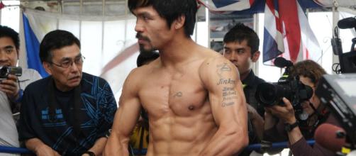 Manny Pacquiao flexing his muscles during an open-door workout at Wildcard Gym – image credit: Showtime Boxing/ Flickr Photos