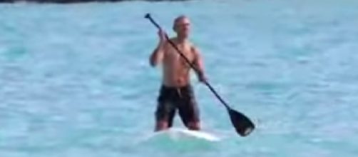 Former President Obama paddle boards shirtless Hawai. [Image source/C FourYou YouTube video]