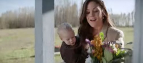Elizabeth (Erin Krakow) of "When Calls the Heart" is flattered by the gift at her door in a Season 7 peek .[Image source:HallmarkChannel-YouTube]