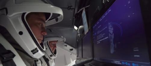 Commercial crew astronauts inside SpaceX’s Crew Dragon. [Image source/SciNews YouTube video]