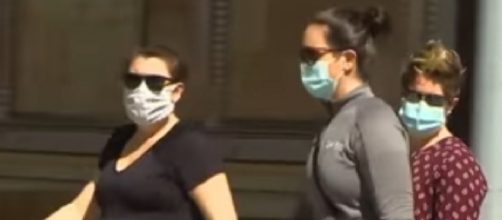 Battle over wearing face masks as pandemic rages on. [Image source/ABC News YouTube video]