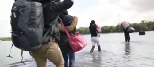 Thousands of undocumented migrants wade through the Rio Grande (Image source: Sky News/YouTube)
