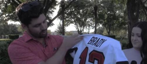 Kennedy shows the signed jersey he received from Brady (Image source: Tampa Bay Times/YouTube)