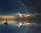 Una barca sotto a un cielo stellato (© Pixabay).