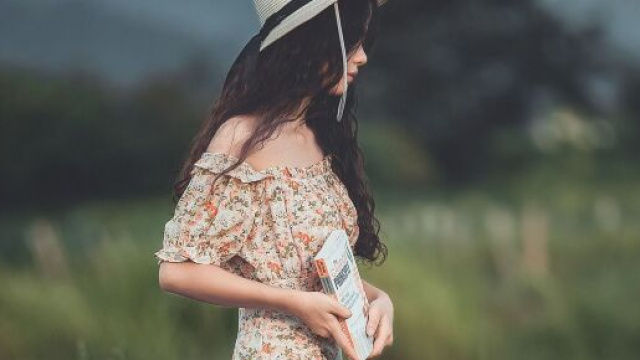 Giovane donna con capello e abito a fiori © Immagine di Pixabay.